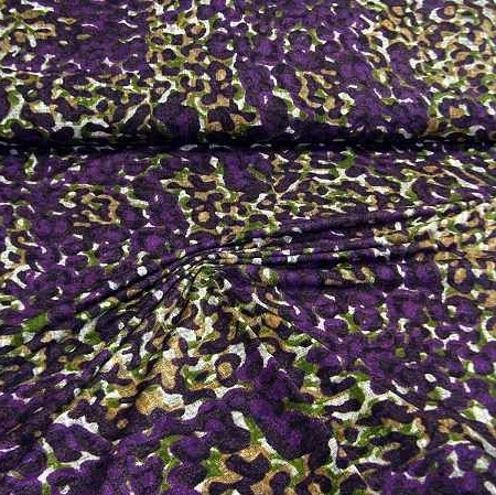 Viscose tricot met paars groen mosterd vlekkenmotief met een beetje linnenstructuur.