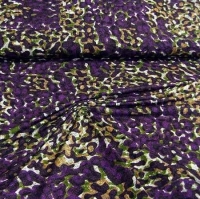 Viscose tricot met paars groen mosterd vlekkenmotief met een beetje linnenstructuur.